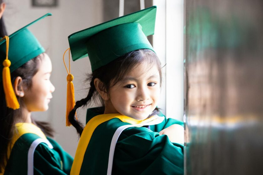 Little girl with cap and gown on.